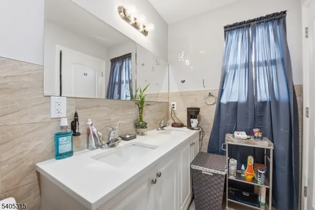 a bathroom with a sink mirror and vanity