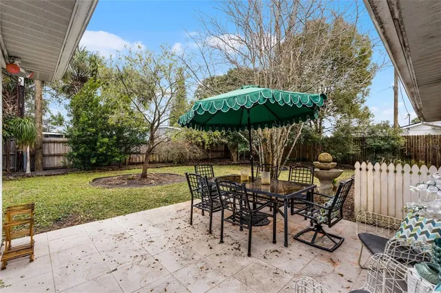a view of a tables and chairs under an umbrella