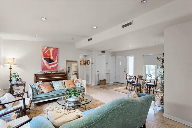 a living room with furniture and painting on the wall