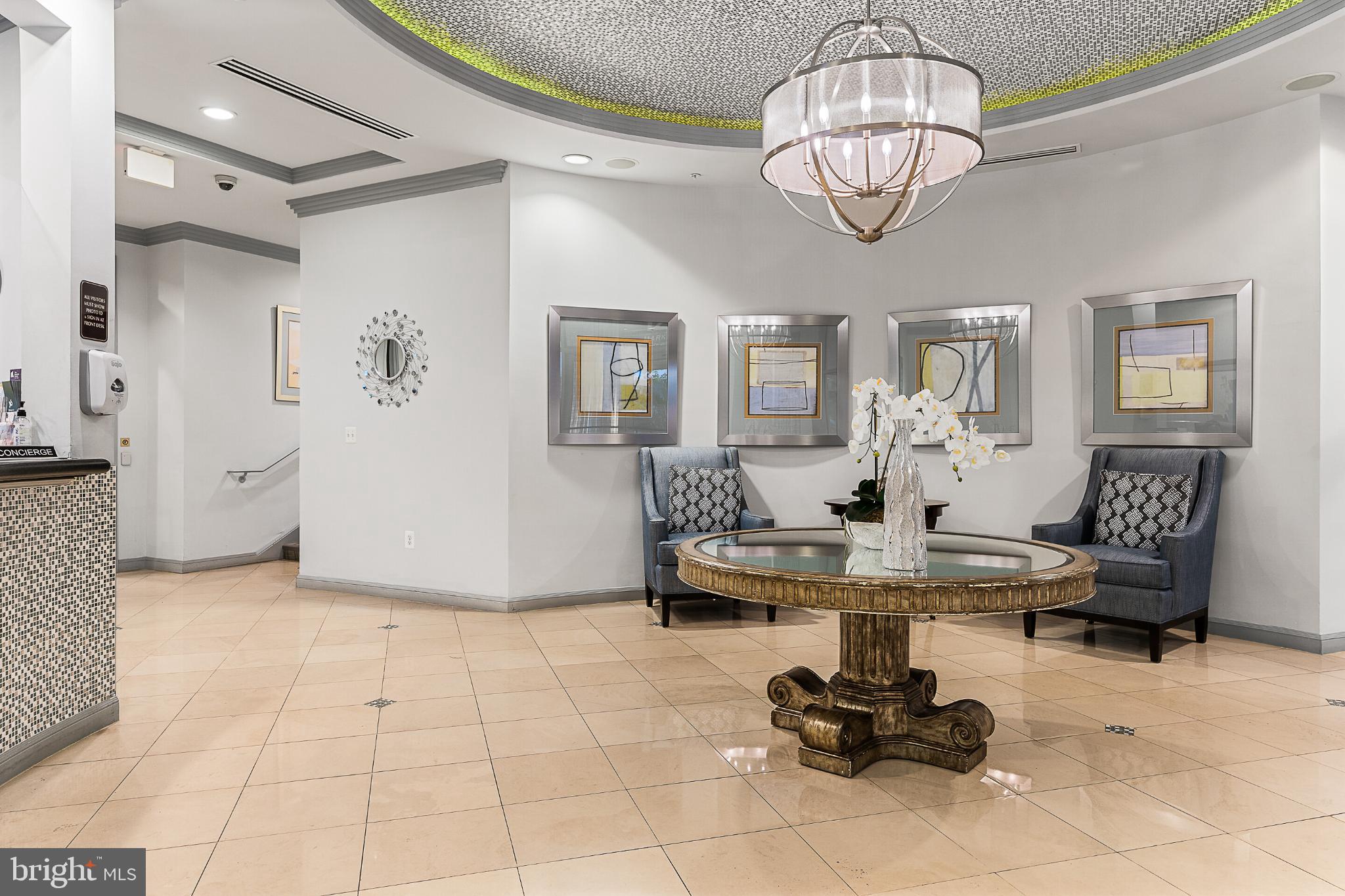 12001 Market Street, Unit T37 Reston, VA 20190 - Photo 5 of 14 Elegant lobby with stylish decor accents.
