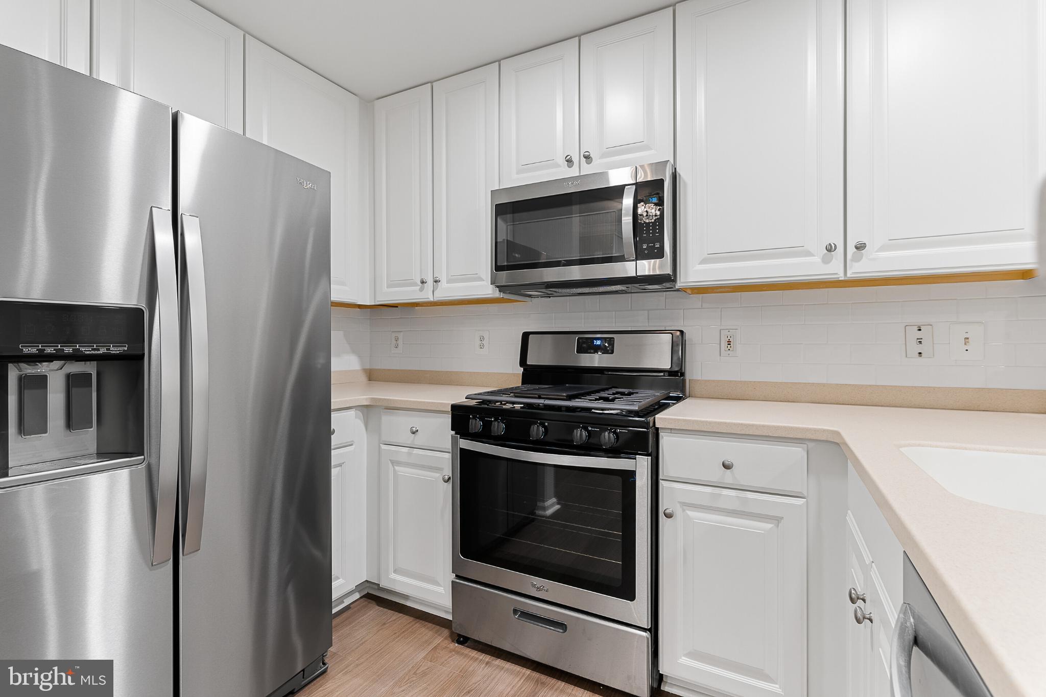 12001 Market Street, Unit T37 Reston, VA 20190 - Photo 7 of 14 Modern kitchen with sleek stainless appliances.
