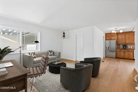 a living room with furniture and kitchen view