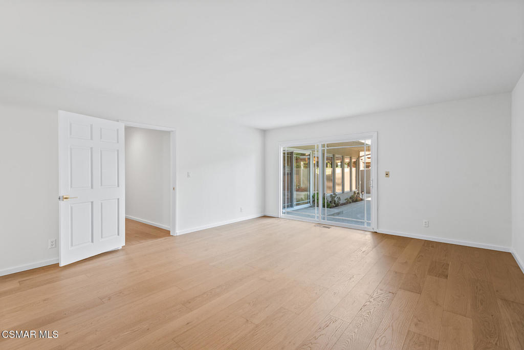 16138 Meadowcrest Road Sherman Oaks, CA 91403 - Photo 30 of 36 a view of an empty room with wooden floor and a window
