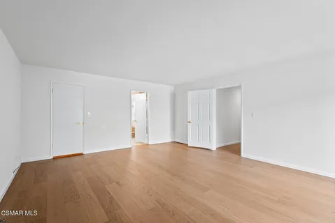 a view of an empty room and wooden floor