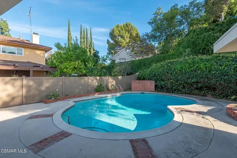 a view of a swimming pool with a patio