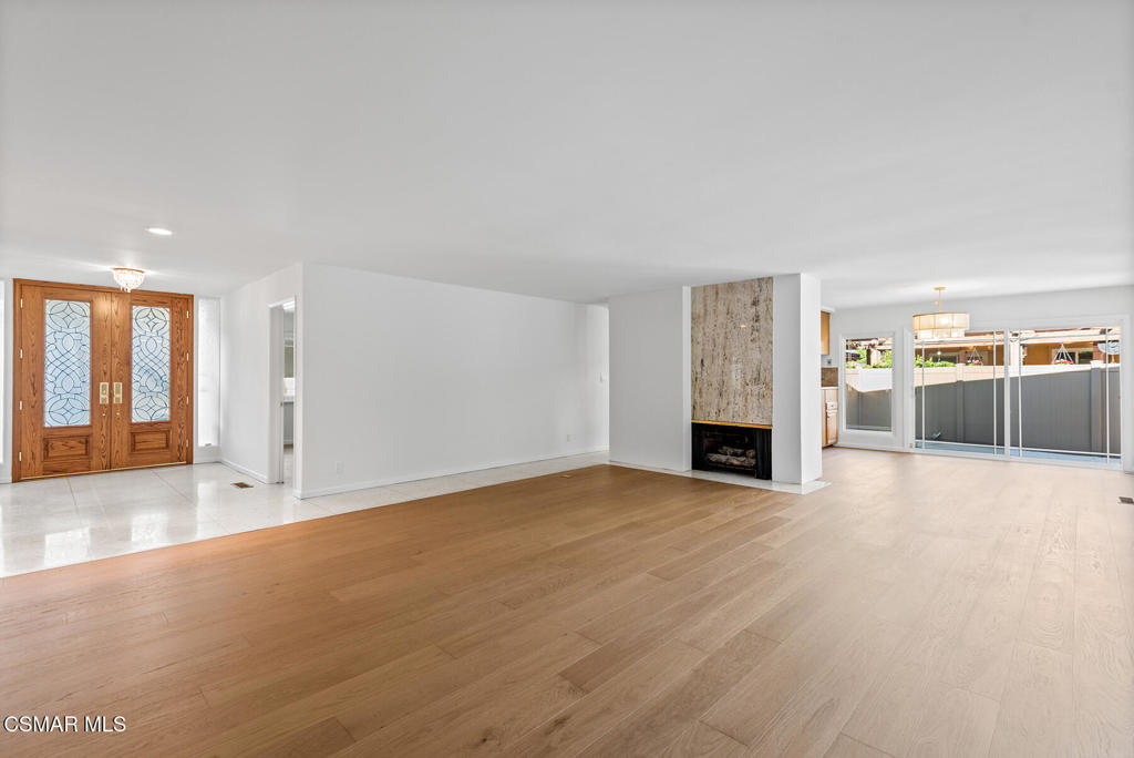 16138 Meadowcrest Road Sherman Oaks, CA 91403 - Photo 9 of 36 a view of a big room with wooden floor and windows