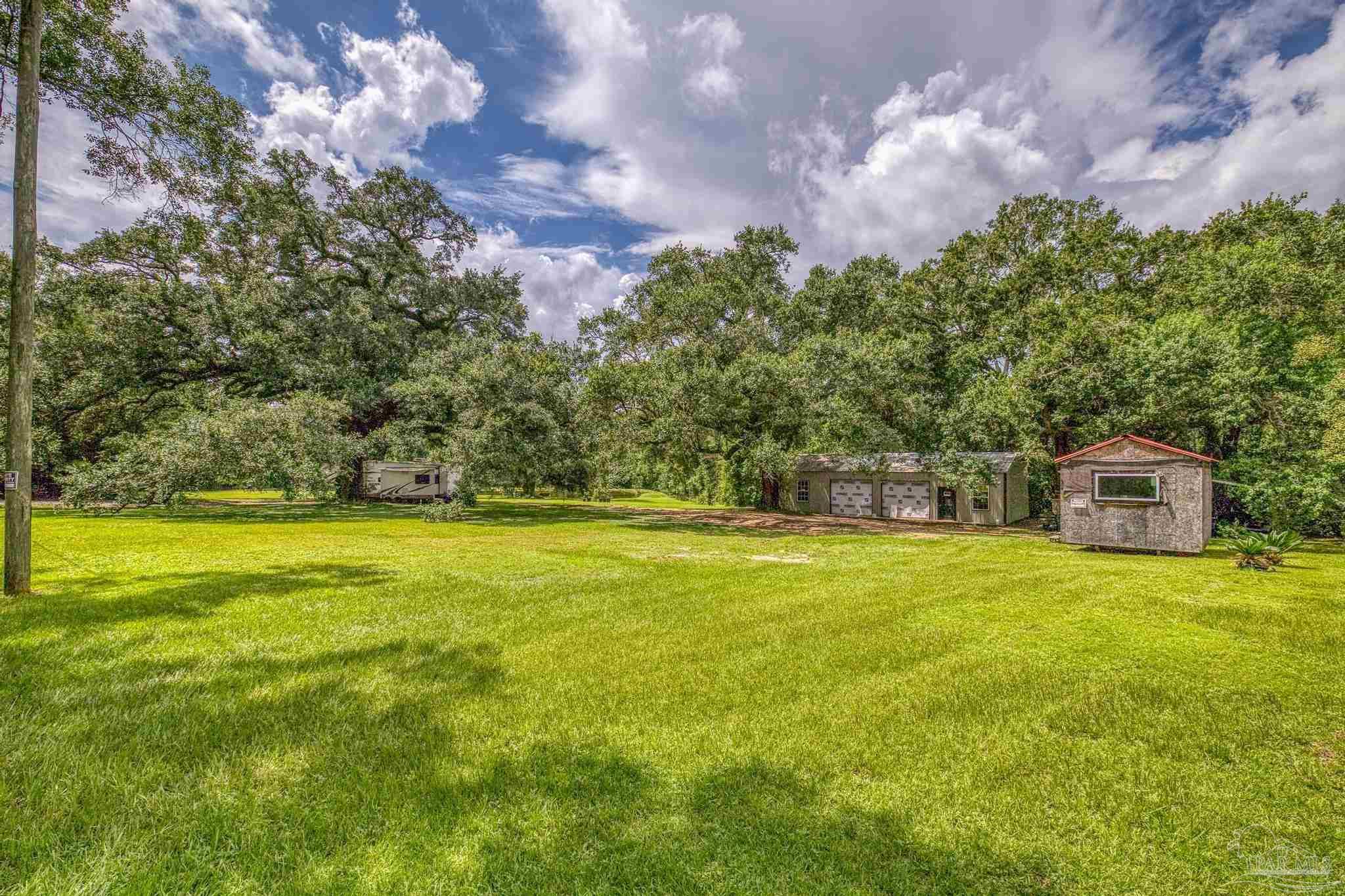 2345 Pompano Street Cantonment, FL 32533 - Photo 3 of 48 a view of a house with a big yard