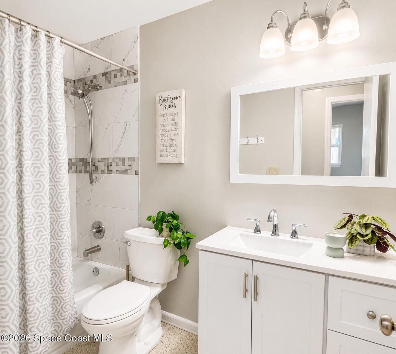 987 Kings Post Road Rockledge, FL 32955 - Photo 20 of 30 a bathroom with a sink toilet a mirror and shower