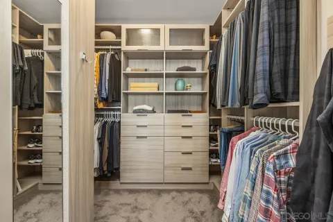 a large bed sitting in a spacious bedroom next to a window