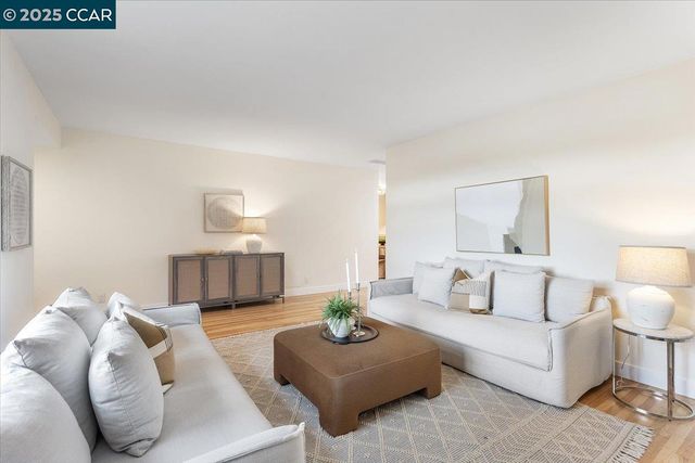 a living room with furniture and a lamp