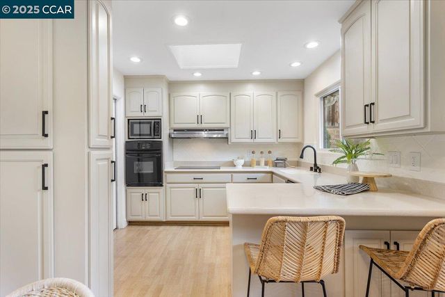 a kitchen with stainless steel appliances granite countertop a sink and cabinets