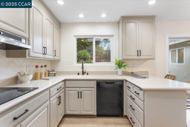 a kitchen with a sink stove and cabinets