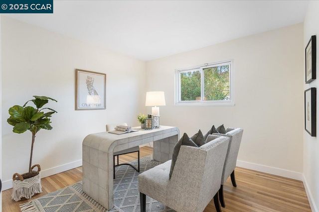 a view of a dining room with furniture and a potted plant