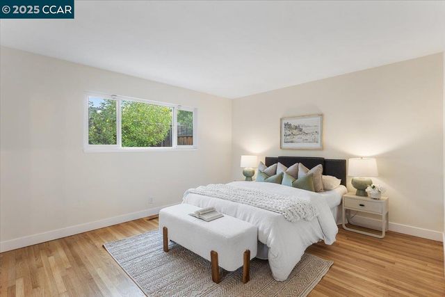 a bedroom with a bed and a night stand