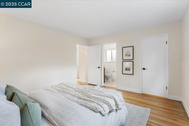 a bedroom with a bed and a wooden floor