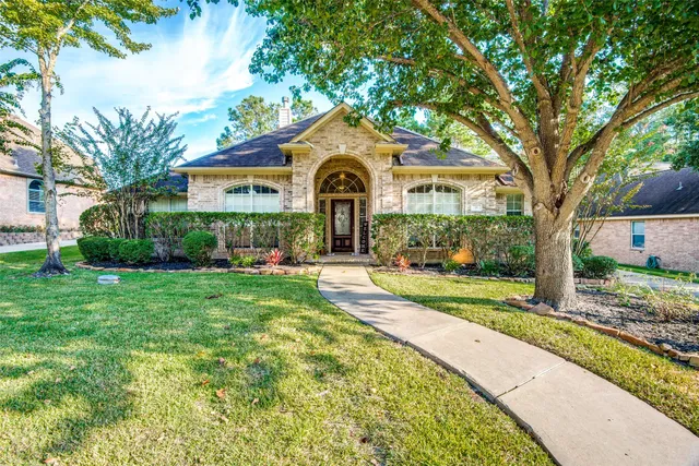 a front view of a house with yard and green space
