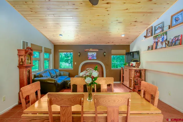 a living room with fireplace furniture and a large window