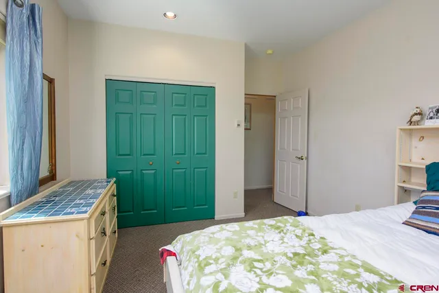 a bedroom with a bed and a dresser