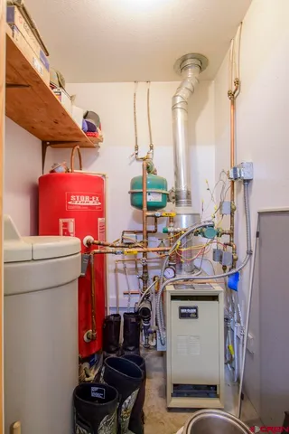 a view of a house with a yard and large trees
