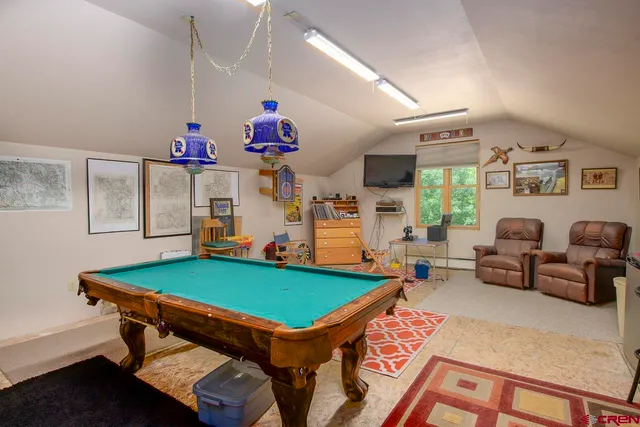 a room with musical instrument pool table and windows