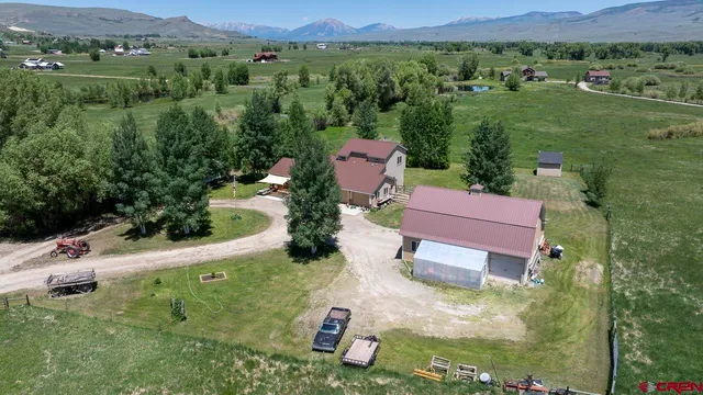 an aerial view of a house with a yard