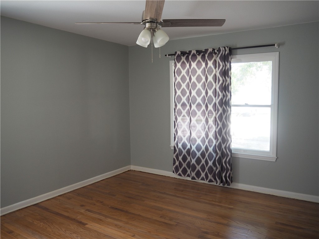 1010 Deforrest Street Corpus Christi, TX 78404 - Photo 12 of 22 wooden floor in an empty room with a window