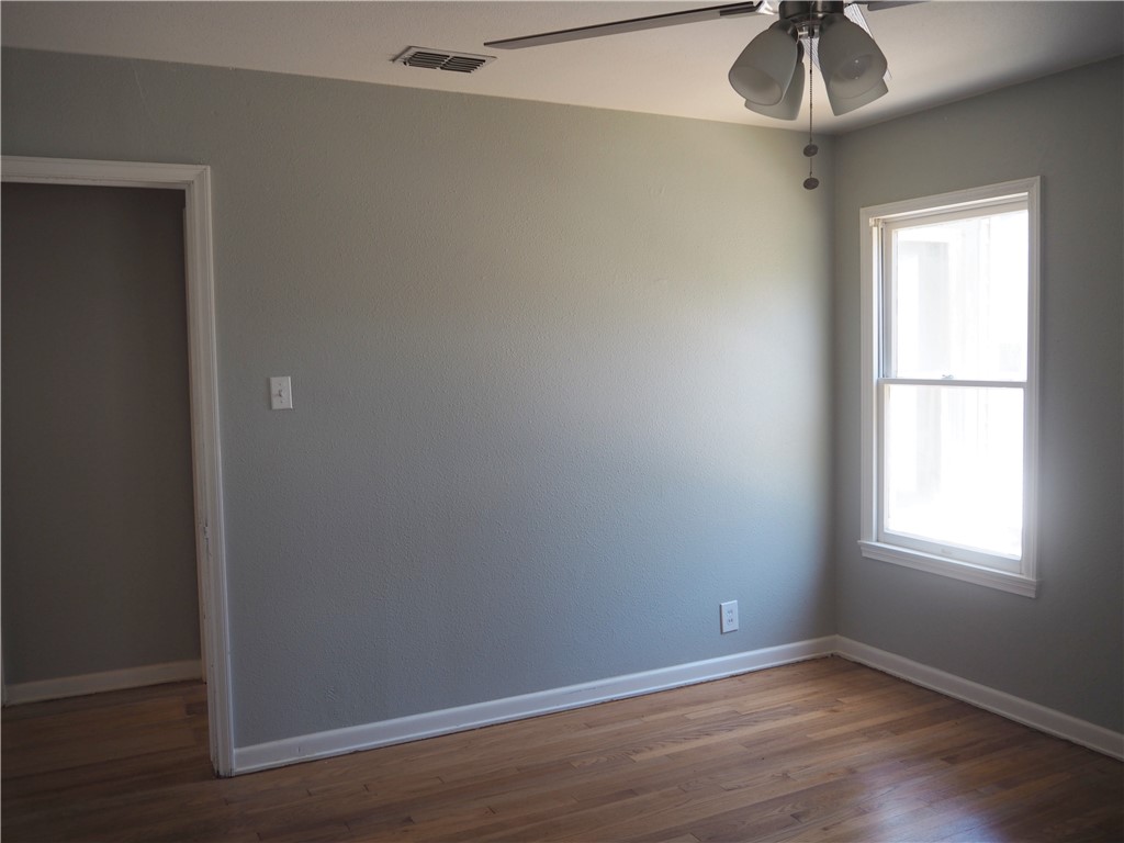 1010 Deforrest Street Corpus Christi, TX 78404 - Photo 13 of 22 an empty room with a window and wooden floor