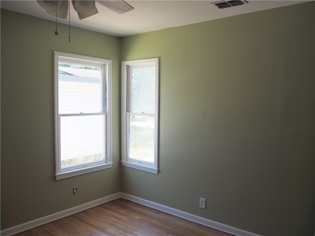 1010 Deforrest Street Corpus Christi, TX 78404 - Photo 14 of 22 a view of an empty room with wooden floor and a window