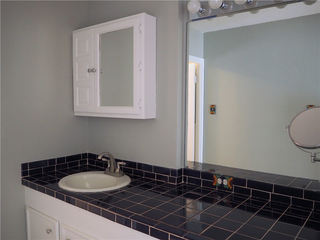 1010 Deforrest Street Corpus Christi, TX 78404 - Photo 19 of 22 a bathroom with a sink and a mirror