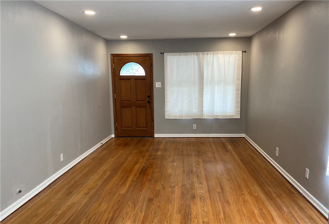 1010 Deforrest Street Corpus Christi, TX 78404 - Photo 2 of 22 an empty room with wooden floor and windows