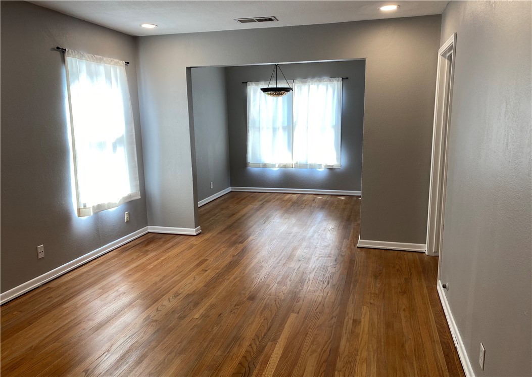1010 Deforrest Street Corpus Christi, TX 78404 - Photo 3 of 22 an empty room with wooden floor and windows