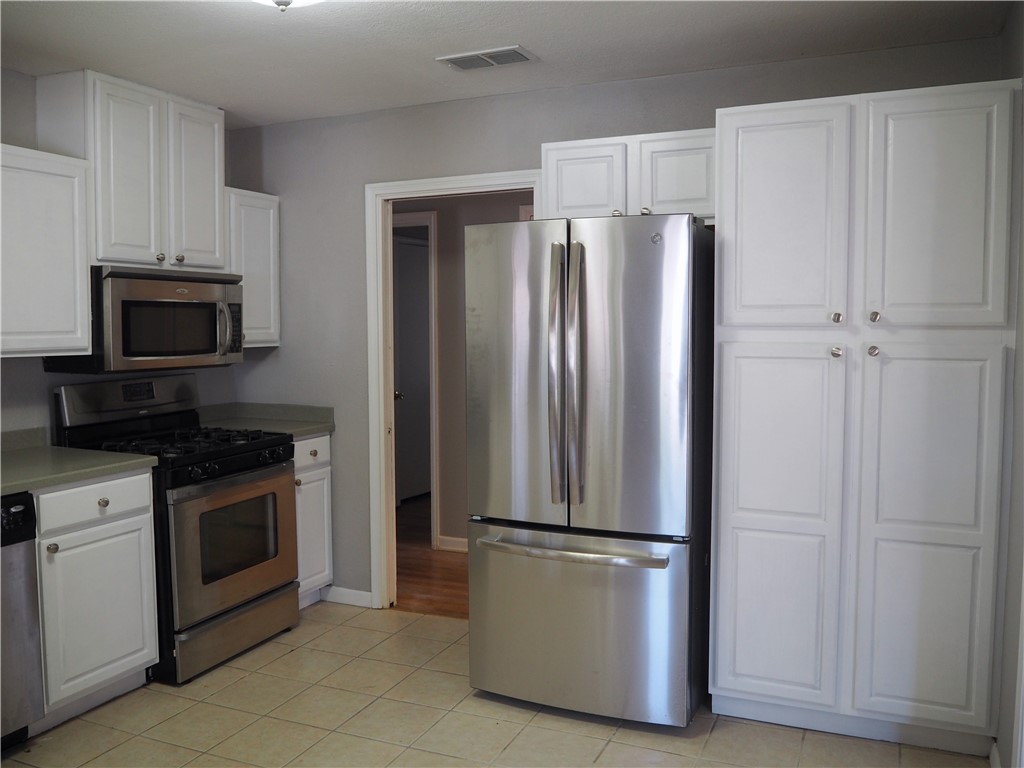 1010 Deforrest Street Corpus Christi, TX 78404 - Photo 5 of 22 a metallic refrigerator freezer sitting in a kitchen