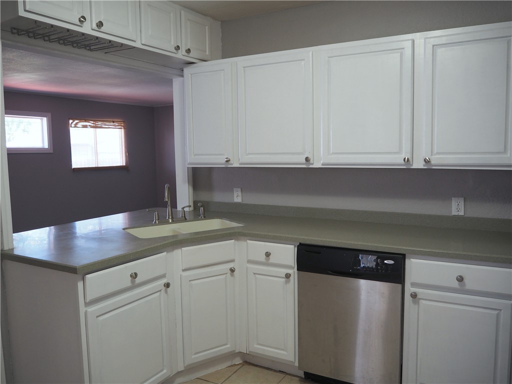 1010 Deforrest Street Corpus Christi, TX 78404 - Photo 6 of 22 a kitchen with granite countertop white cabinets and sink