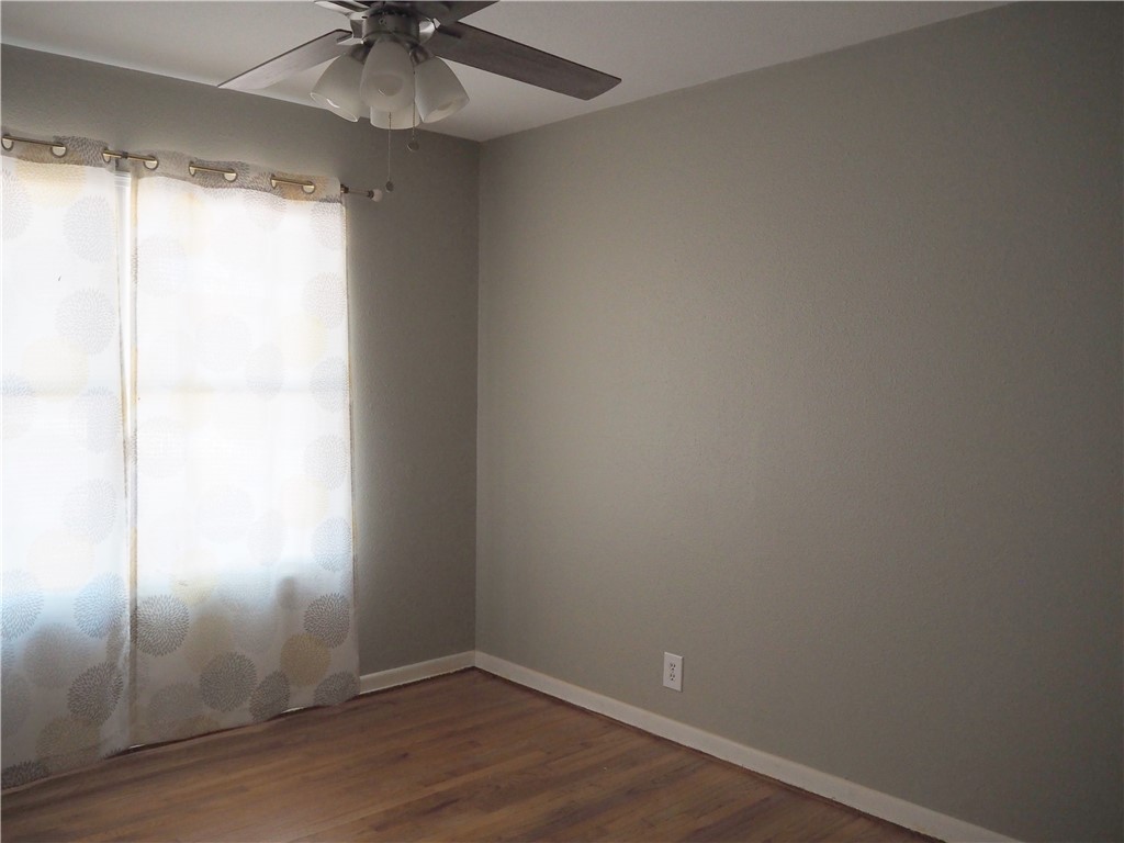 1010 Deforrest Street Corpus Christi, TX 78404 - Photo 9 of 22 an empty room with a window and a fan