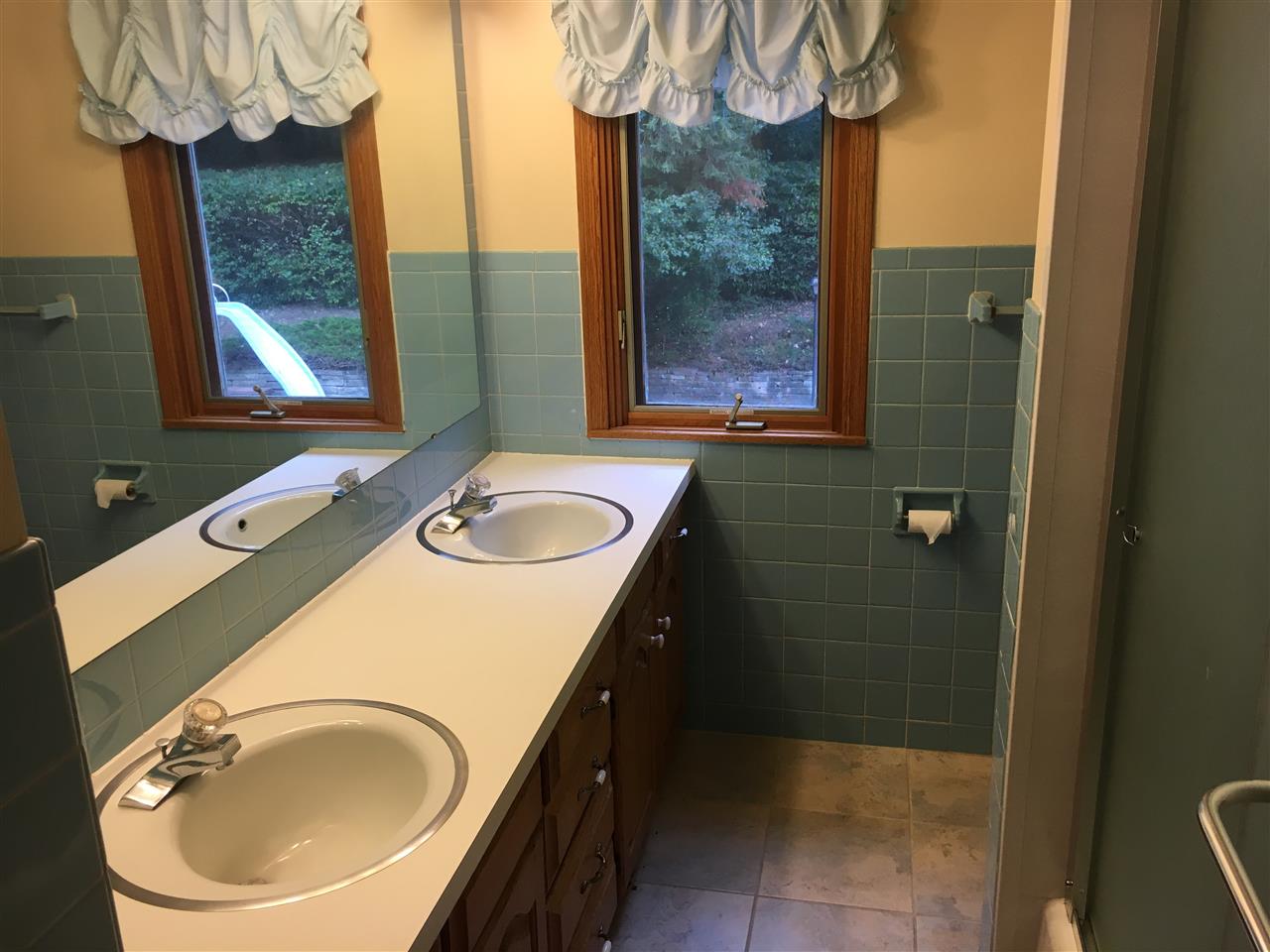 3512 Spring Creek Road Rockford, IL 61107 - Photo 23 of 25 a bathroom with a sink a mirror and a shower