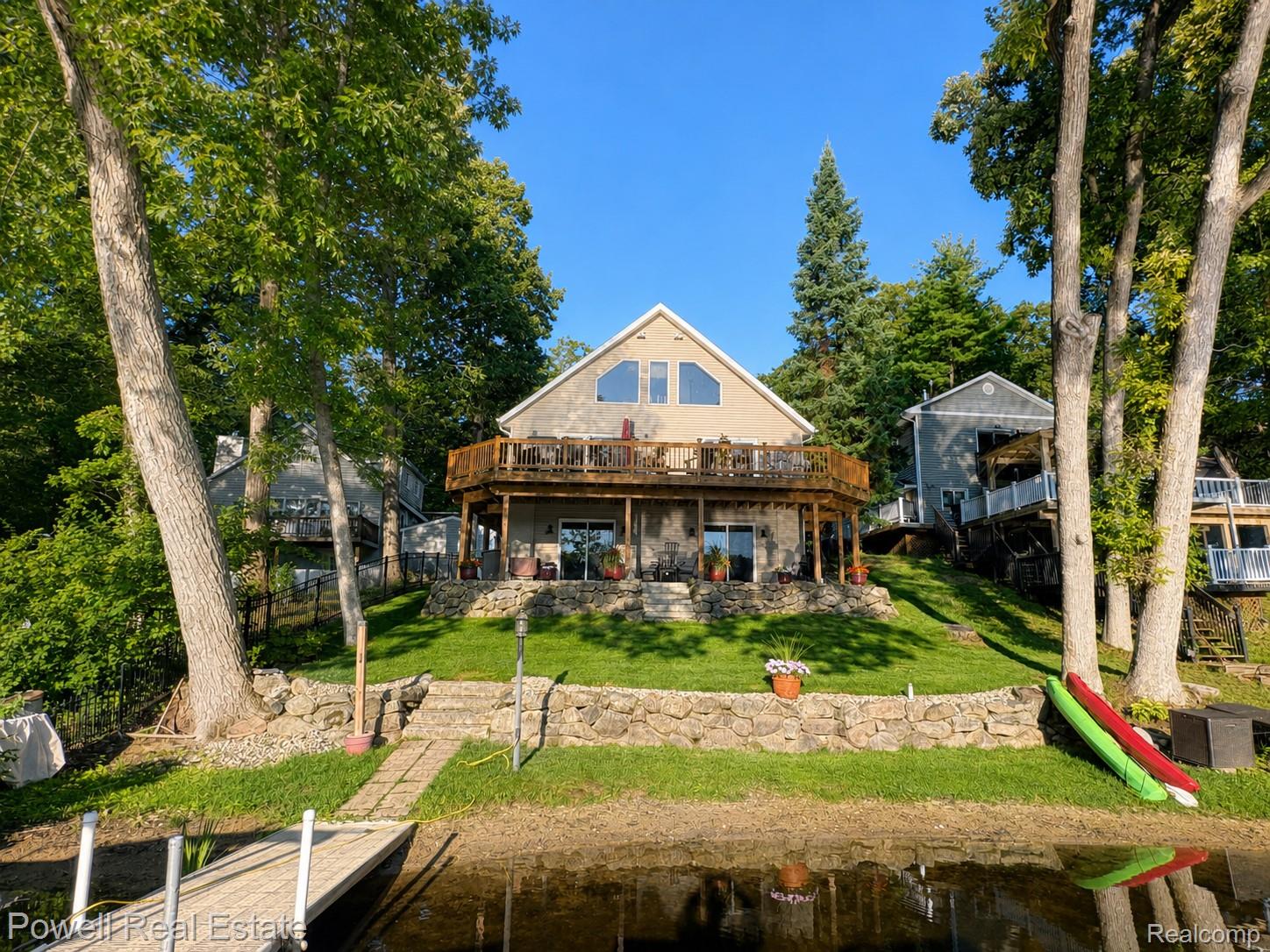 6807 Big Trail Road Holly, MI 48442 - Photo 2 of 45 Two-level exterior decking, stone retaining wall, and a private dock