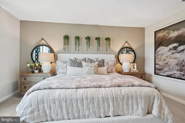 a bedroom with a bed and dresser with mirror