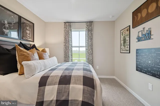 a bedroom with a bed and painting on the wall