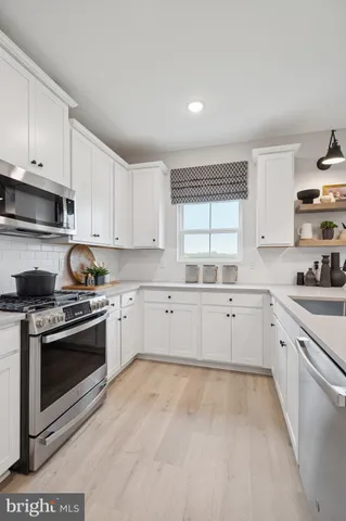 a kitchen with granite countertop white cabinets and appliances