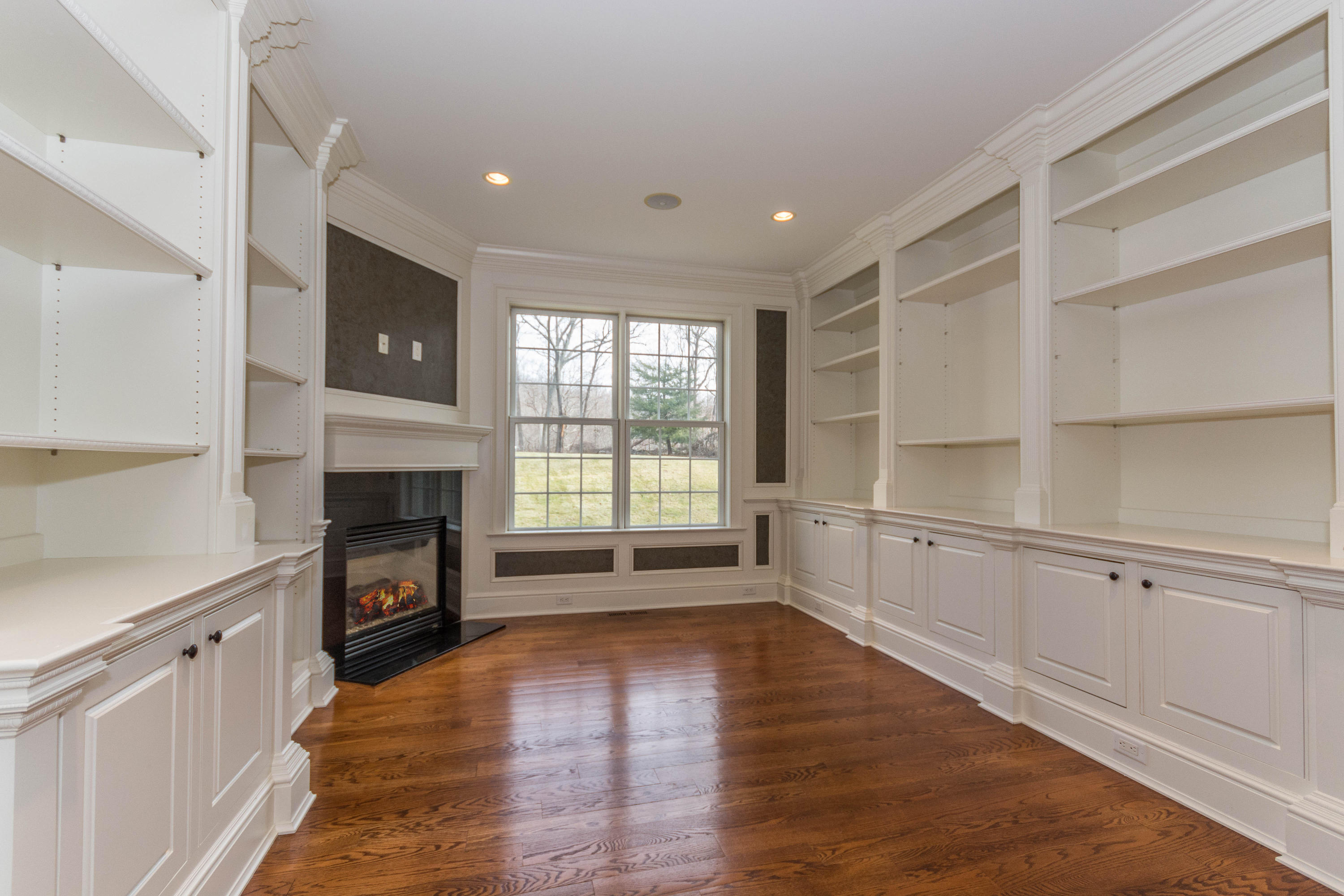 200 Limestone Road Ridgefield, CT 06877 - Photo 14 of 25 a view of an empty room with a fireplace and a window
