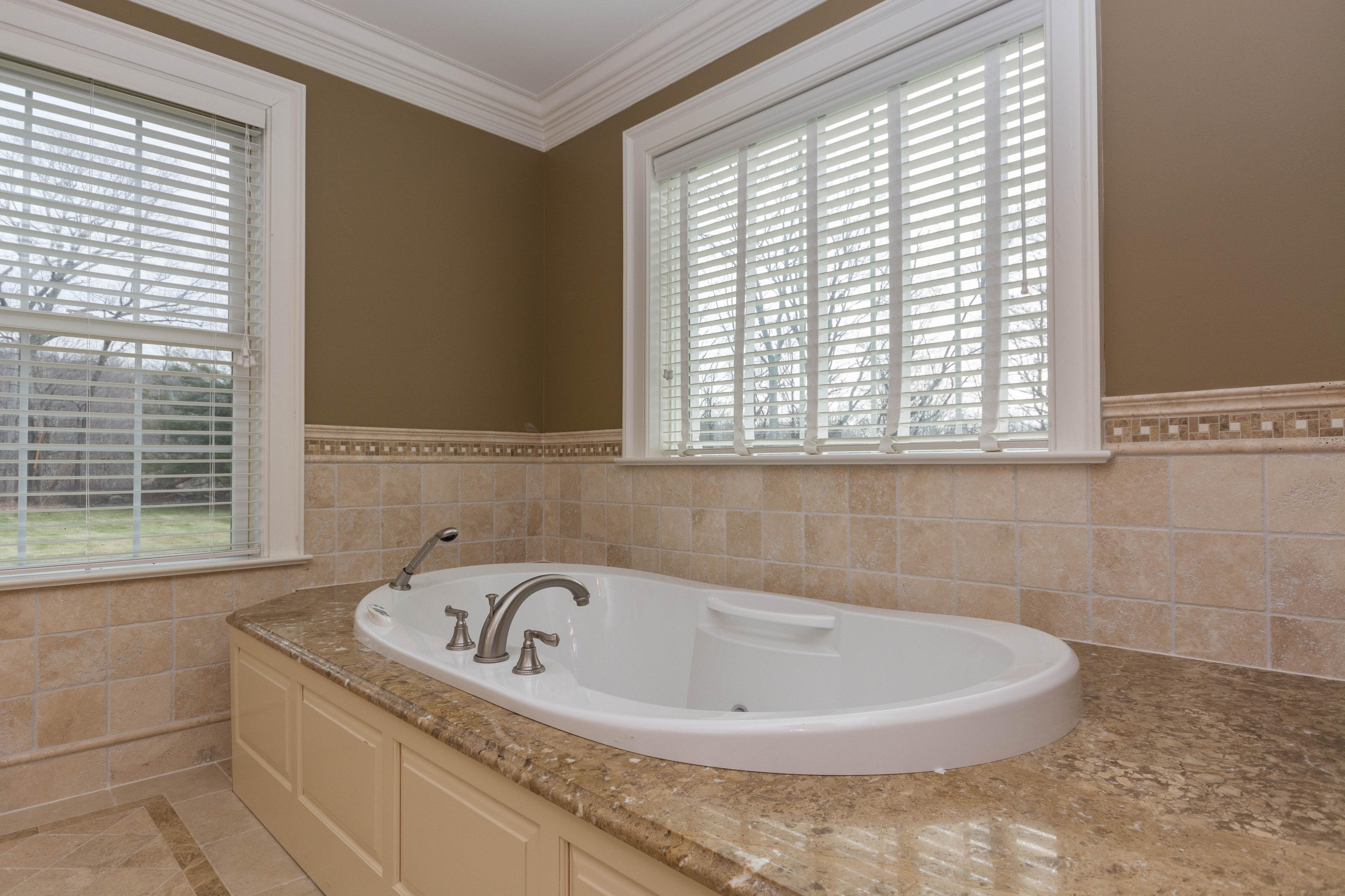 200 Limestone Road Ridgefield, CT 06877 - Photo 20 of 25 a bath tub sitting in a bathroom next to a window