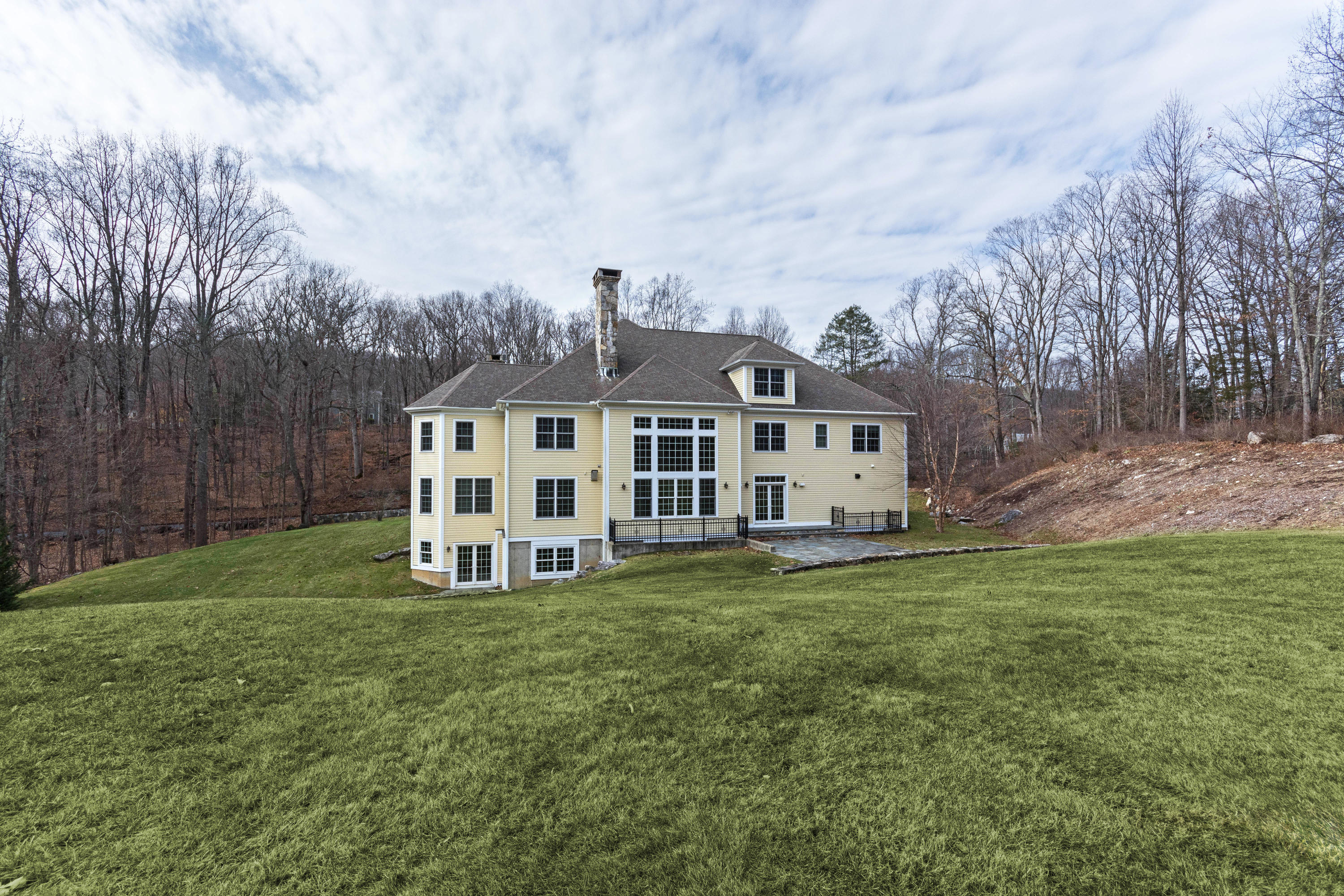 200 Limestone Road Ridgefield, CT 06877 - Photo 2 of 25 a view of a house with a big yard and large trees