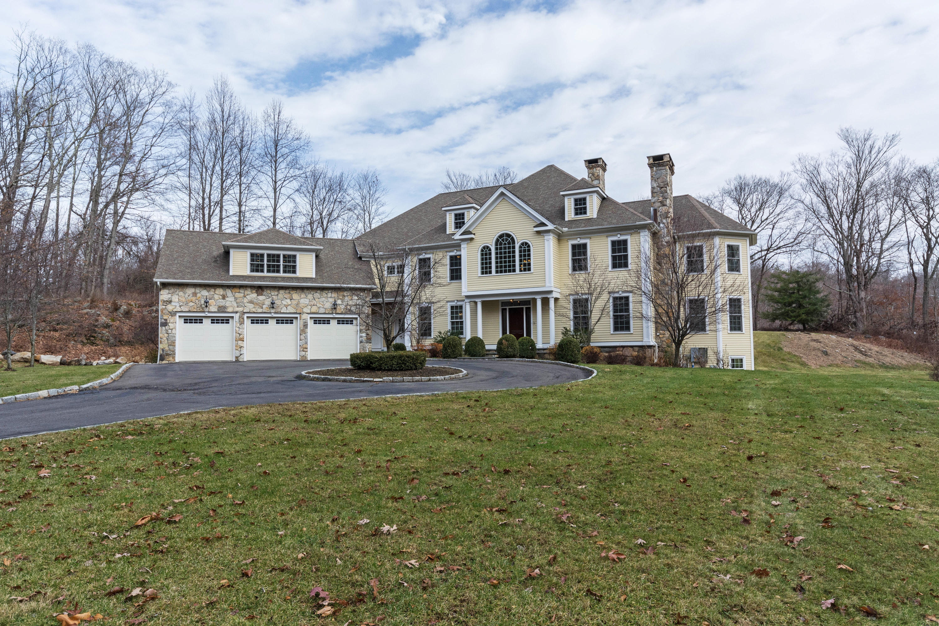 200 Limestone Road Ridgefield, CT 06877 - Photo 23 of 25 a front view of a house with a yard table and chairs