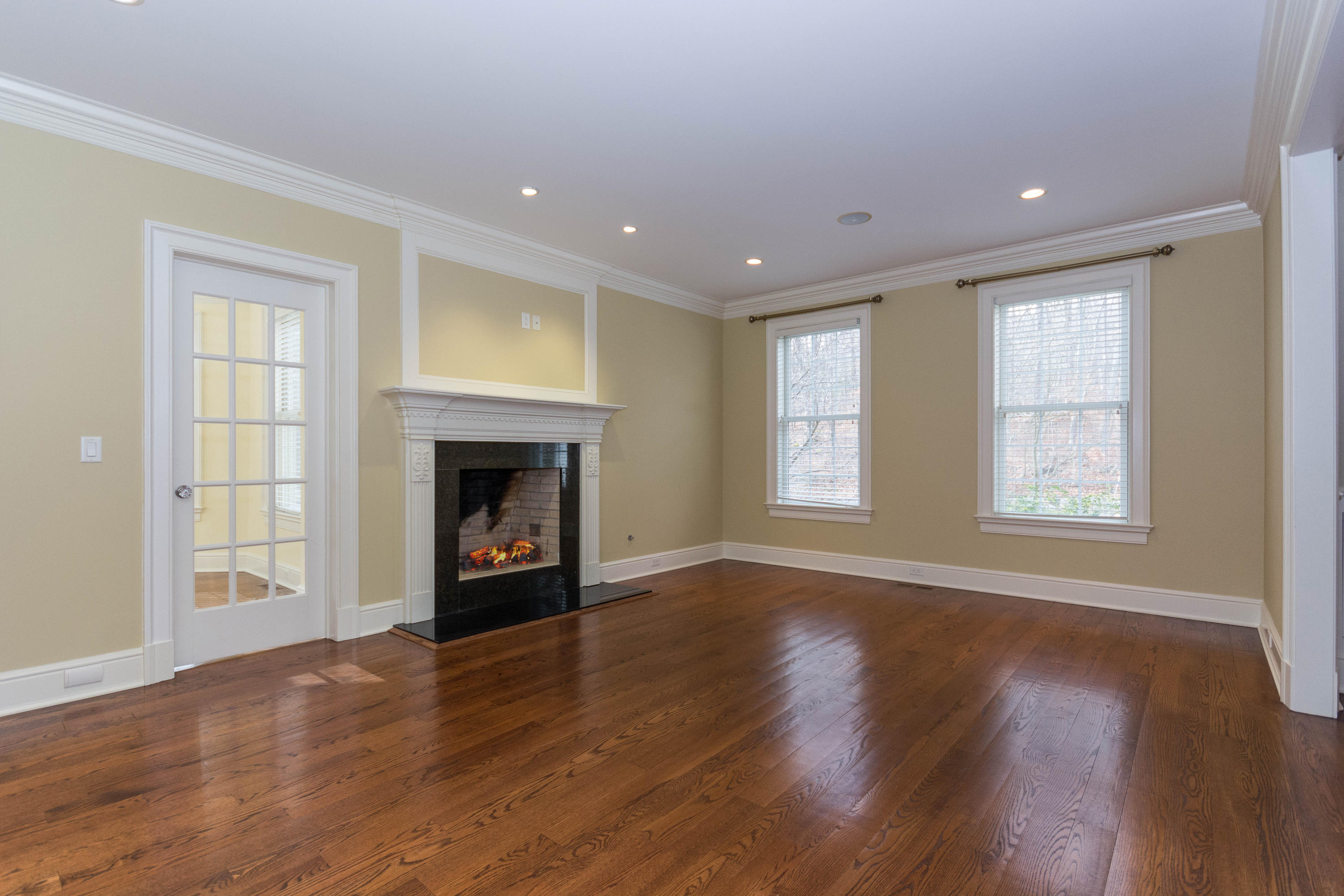200 Limestone Road Ridgefield, CT 06877 - Photo 6 of 25 a view of an empty room with wooden floor fireplace and a window