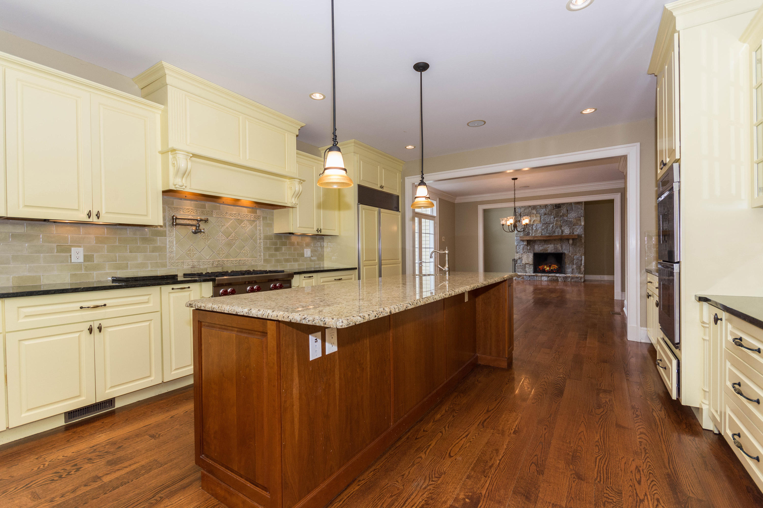200 Limestone Road Ridgefield, CT 06877 - Photo 8 of 25 a kitchen with stainless steel appliances granite countertop wooden floors sink and cabinets
