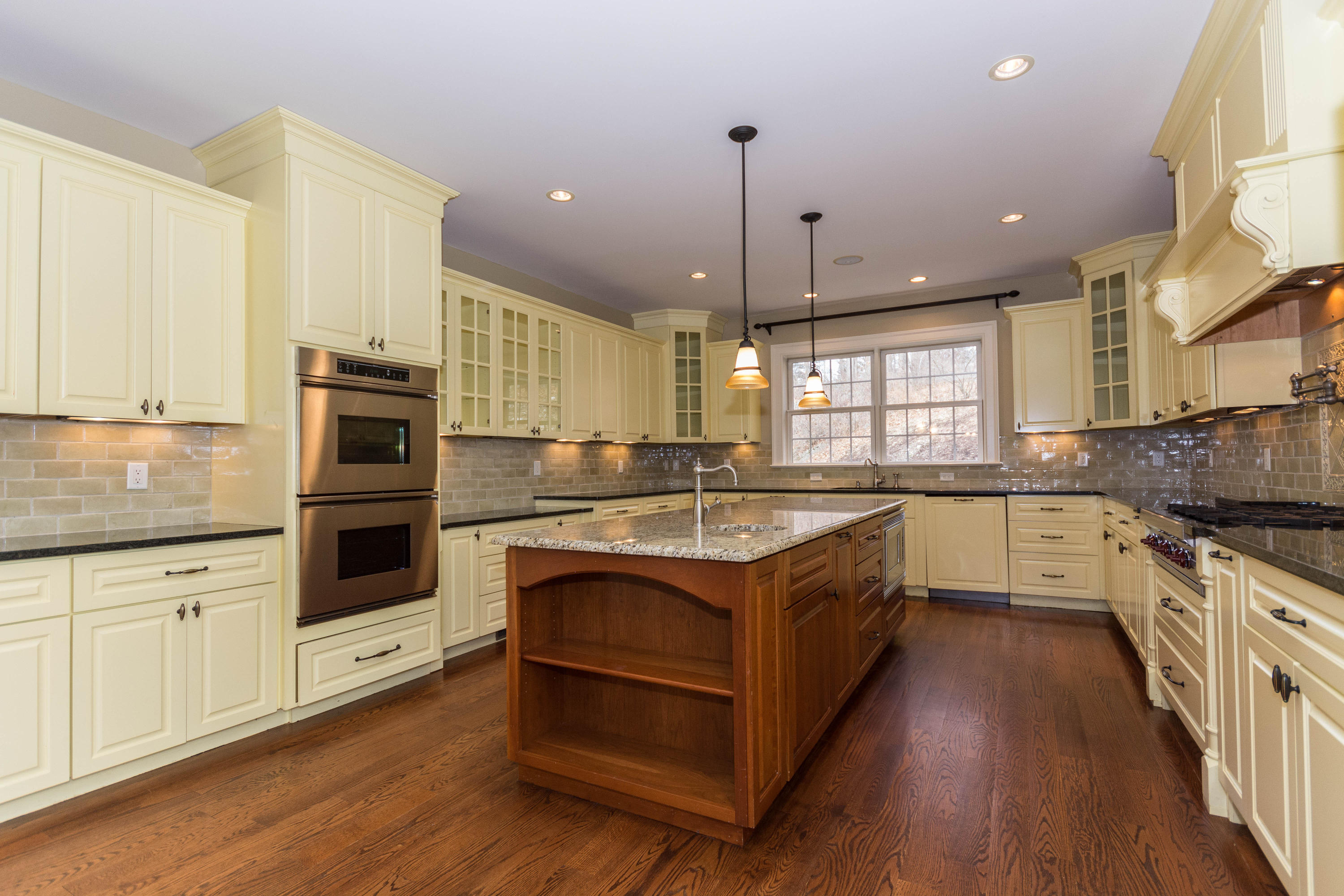 200 Limestone Road Ridgefield, CT 06877 - Photo 9 of 25 a large kitchen with stainless steel appliances granite countertop a stove and a wooden floors