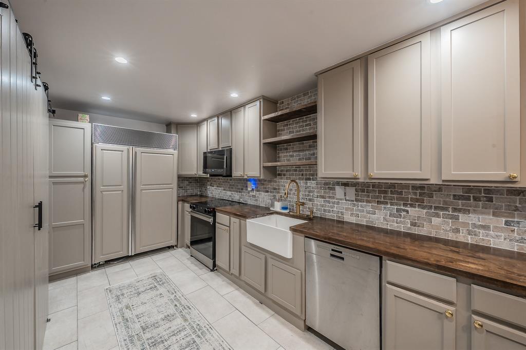 14151 Montfort Drive, Unit 332 Dallas, TX 75254 - Photo 11 of 35 a kitchen with stainless steel appliances granite countertop a sink stove and refrigerator