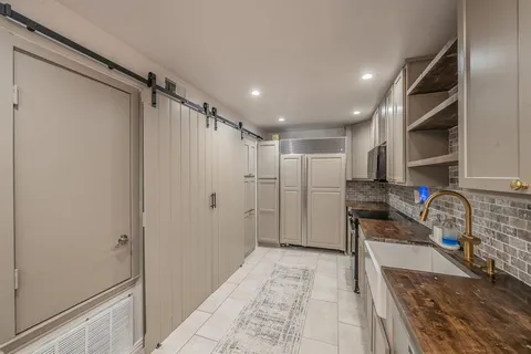 a view of kitchen with furniture and a refrigerator