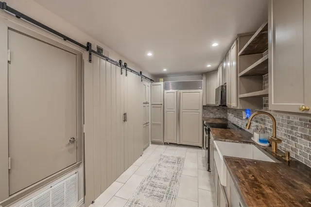 a view of kitchen with furniture and a refrigerator