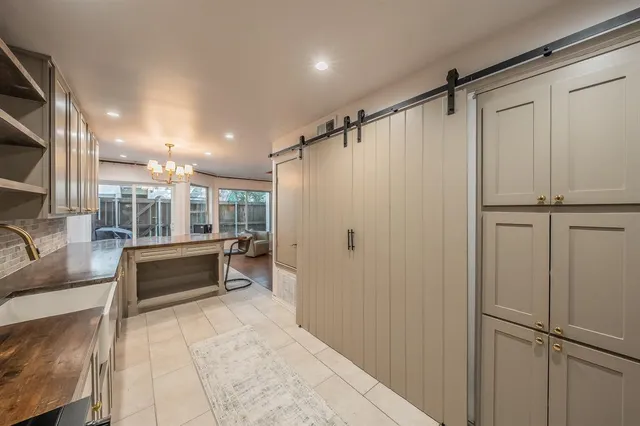 a large kitchen with stainless steel appliances granite countertop a stove and a sink